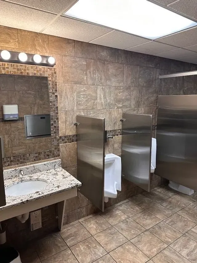 Spotless commercial restroom with clean granite counters